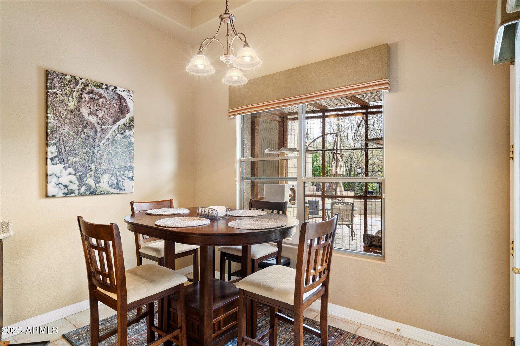 6867 East Crimson Sky Trail Scottsdale, AZ 85266 - Photo 23 of 97 a view of a dining room with furniture window and wooden floor