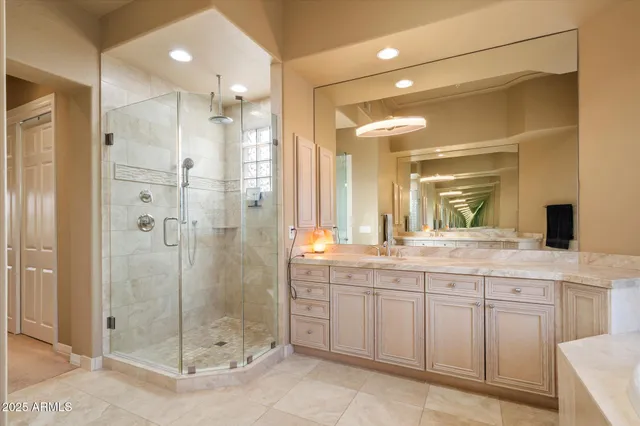 a bedroom with a bed and a dresser with bookshelf