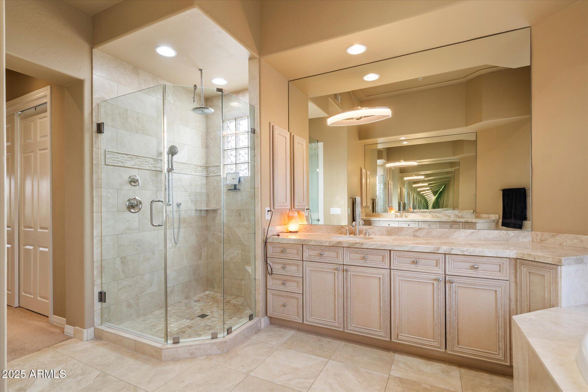 6867 East Crimson Sky Trail Scottsdale, AZ 85266 - Photo 30 of 97 a bathroom with a granite countertop sink mirror and shower