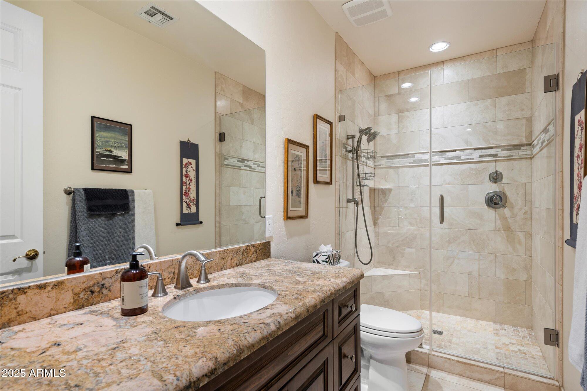 6867 East Crimson Sky Trail Scottsdale, AZ 85266 - Photo 34 of 97 a bathroom with a granite countertop sink toilet and shower
