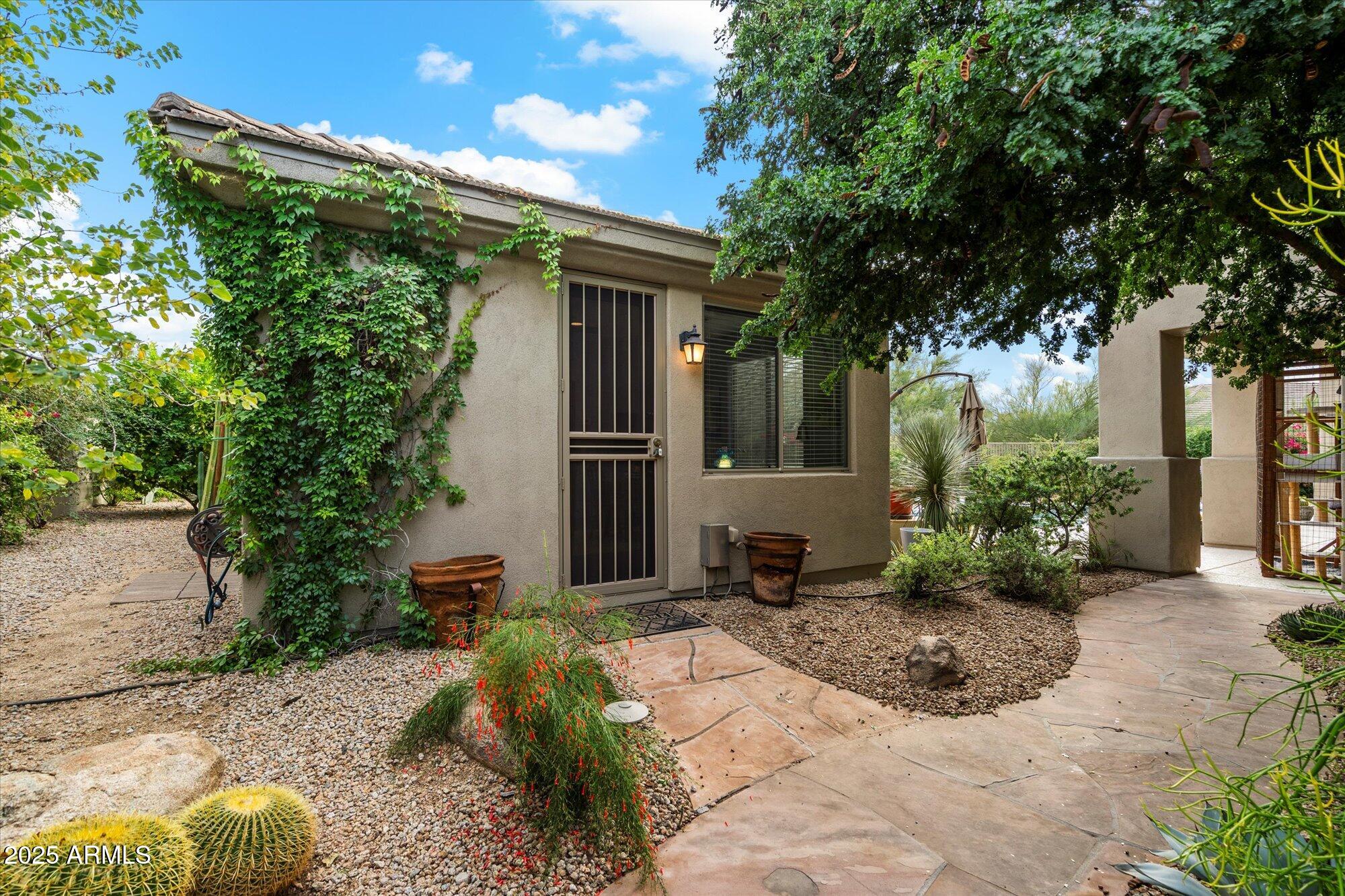 6867 East Crimson Sky Trail Scottsdale, AZ 85266 - Photo 45 of 97 a front view of a house with garden