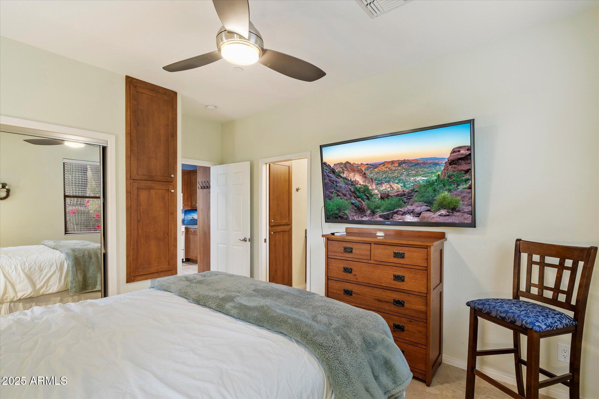 6867 East Crimson Sky Trail Scottsdale, AZ 85266 - Photo 50 of 97 a bedroom with a bed and a dresser with bookshelf