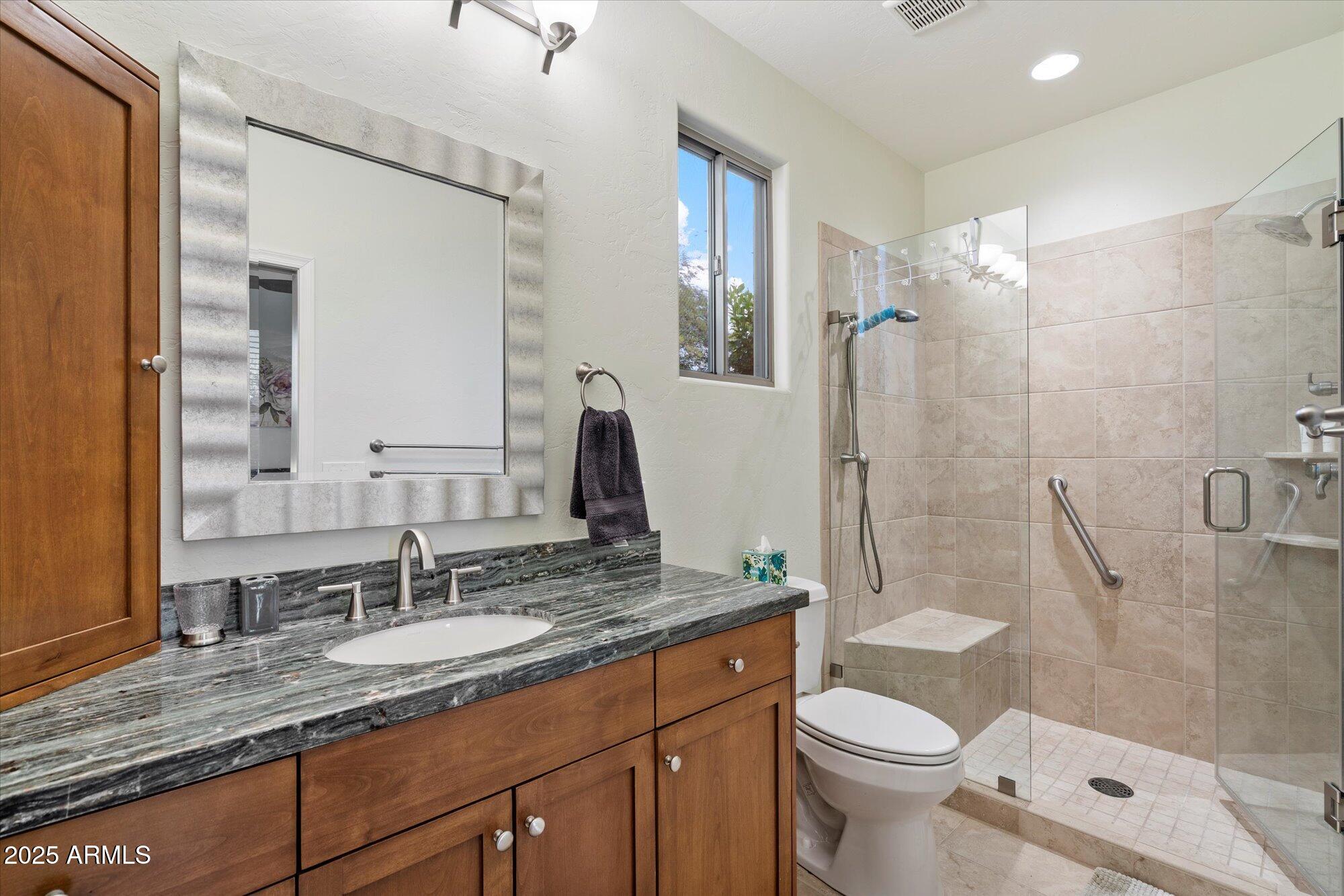 6867 East Crimson Sky Trail Scottsdale, AZ 85266 - Photo 52 of 97 a bathroom with a granite countertop sink toilet and shower