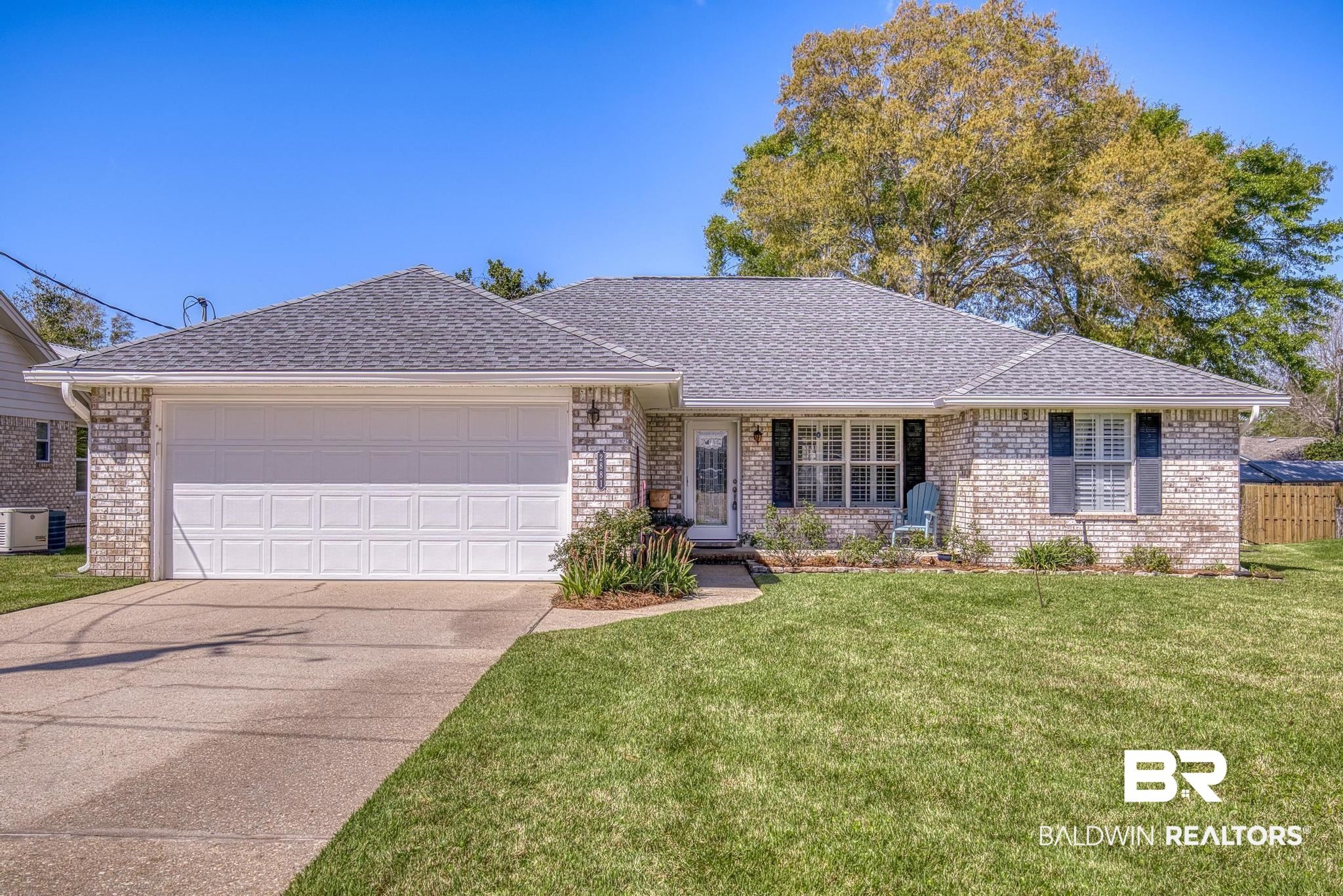 2881 Eslava Circle Lillian, AL 36549 - Photo 1 of 58 Ranch-style home with roof with shingles, an attached garage, driveway, and a front lawn