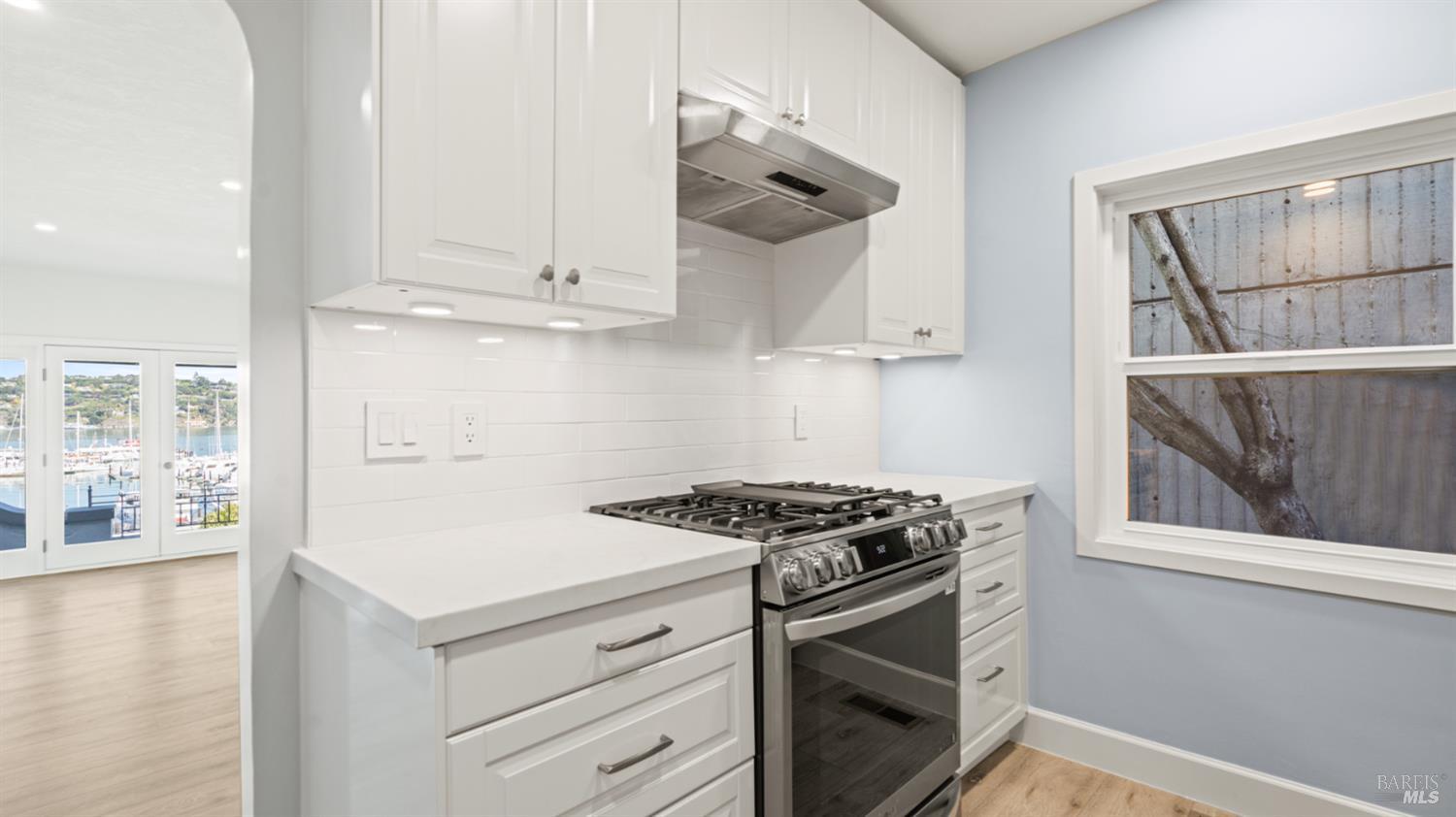 833 Bridgeway, Unit 5 Sausalito, CA 94965 - Photo 19 of 26 a kitchen with stainless steel appliances granite countertop a stove and a refrigerator