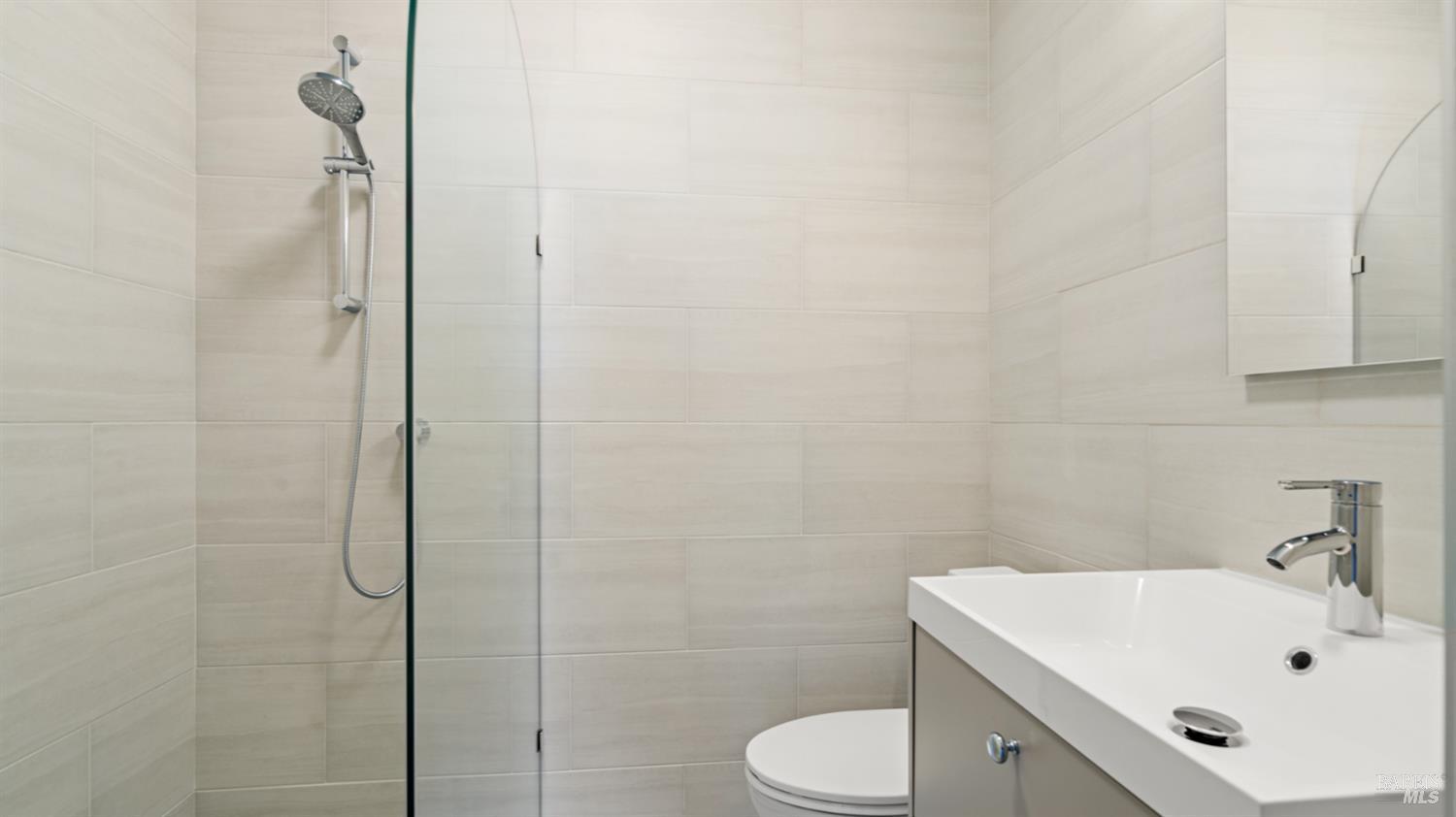 833 Bridgeway, Unit 5 Sausalito, CA 94965 - Photo 5 of 26 a bathroom with a sink a toilet and shower