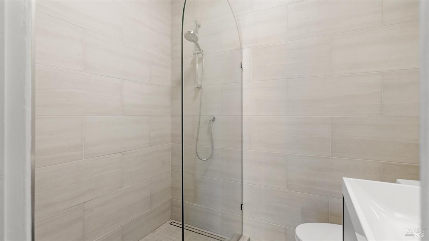 833 Bridgeway, Unit 5 Sausalito, CA 94965 - Photo 6 of 26 a bathroom with a shower and a toilet