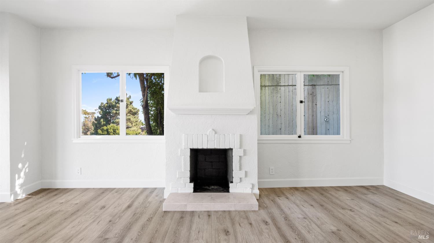833 Bridgeway, Unit 5 Sausalito, CA 94965 - Photo 10 of 26 an empty room with wooden floor and fireplace