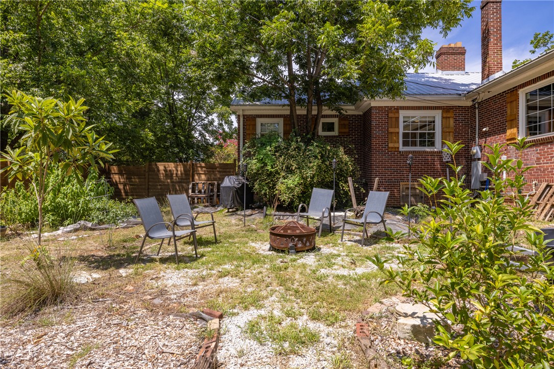704 Cherry Street Pendleton, SC 29670 - Photo 23 of 28 A private backyard oasis with a charming brick exterior, perfect for intimate gatherings around the fire pit.