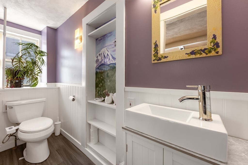 28 Ellsworth Street Medford, MA 02155 - Photo 4 of 23 a bathroom with a toilet sink and mirror