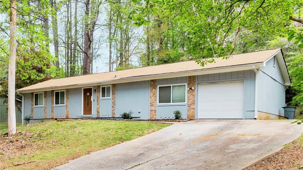 5796 Bobbin Lane Lithonia, GA 30058 - Photo 1 of 17 a front view of a house with a garden