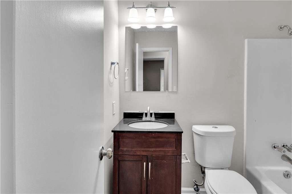 5796 Bobbin Lane Lithonia, GA 30058 - Photo 12 of 17 a bathroom with a toilet sink and mirror