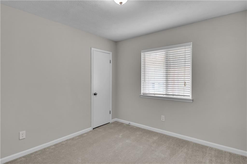5796 Bobbin Lane Lithonia, GA 30058 - Photo 13 of 17 an empty room with a window