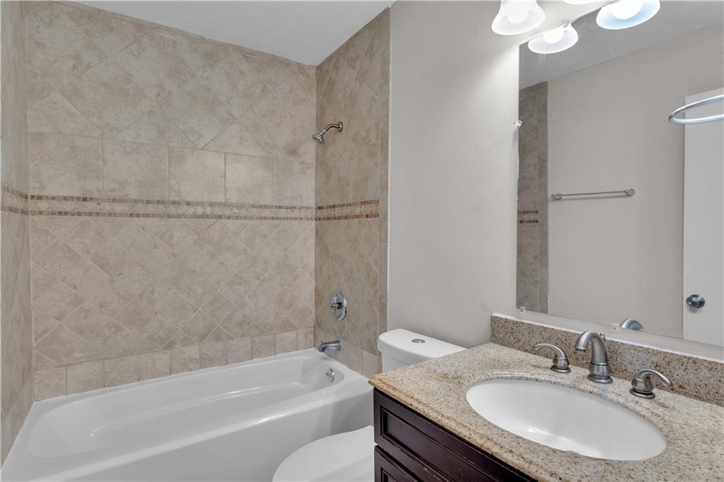 5796 Bobbin Lane Lithonia, GA 30058 - Photo 10 of 17 a bathroom with a granite countertop sink toilet and shower