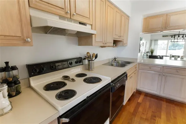 a kitchen with a sink a stove and cabinets
