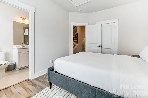 a bedroom with a bed and a view of bathroom