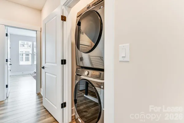 a view of a bedroom with washer and dryer