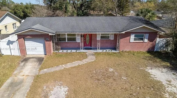 a front view of a house with a garden and yard