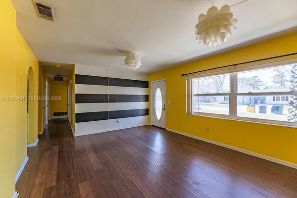 a view of room with wooden floor and window