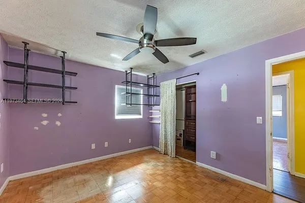 a view of a livingroom with a ceiling fan and window