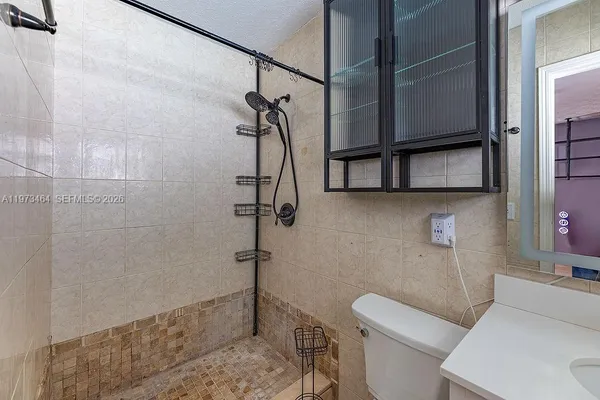 a bathroom with a toilet and a shower