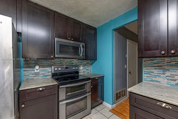 a kitchen with a stove microwave and refrigerator