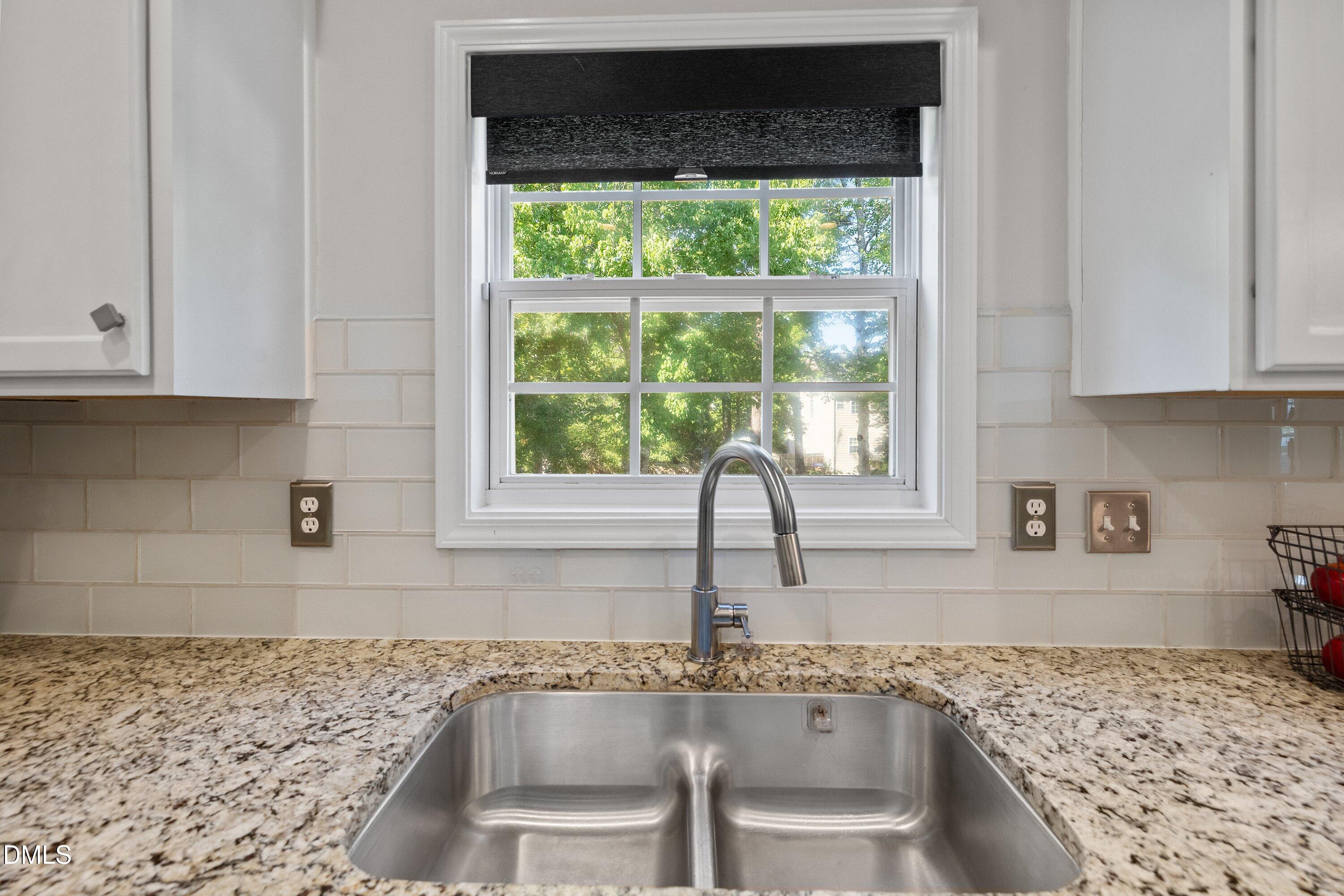 3717 Windmeade Road Wake Forest, NC 27587 - Photo 18 of 51 a kitchen with granite countertop a sink and a stove