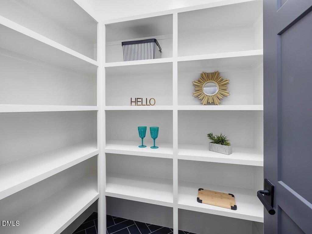 7013 Buckhead Drive Raleigh, NC 27615 - Photo 22 of 80 a shelf with cup and plates