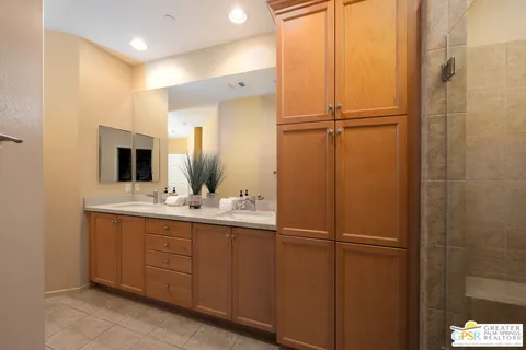 a bathroom with a double vanity sink and mirror