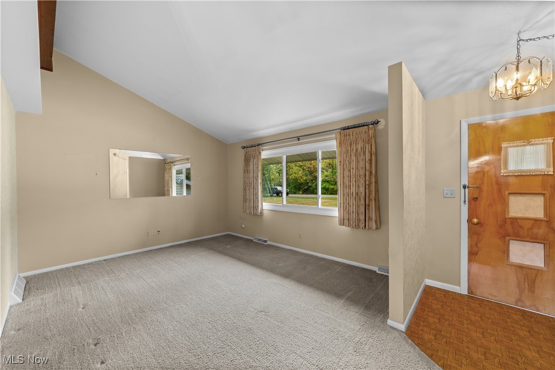 648 Rehwinkle Road Northfield, OH 44067 - Photo 5 of 38 Entrance foyer with lofted ceiling, a chandelier, and carpet