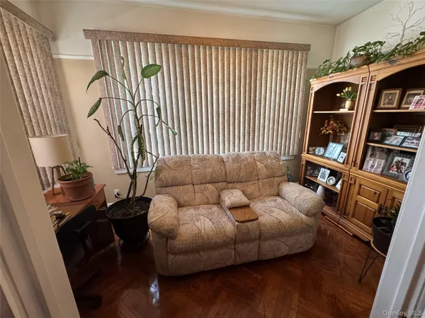 a living room with furniture and a floor to ceiling window