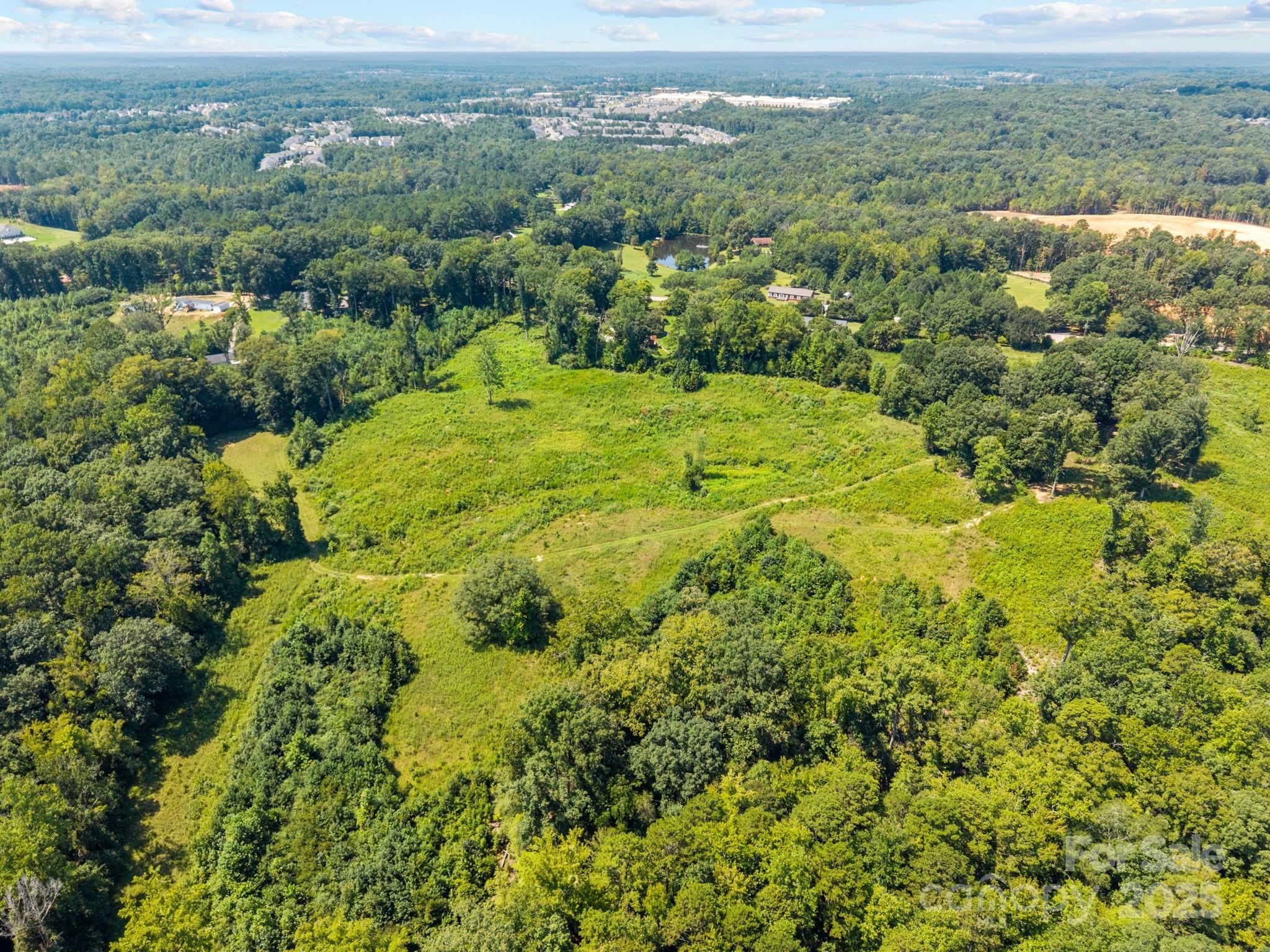 8188 Henry Harris Road, Unit 2 Fort Mill, SC 29707 - Photo 16 of 25 an aerial view of residential houses with outdoor space and trees
