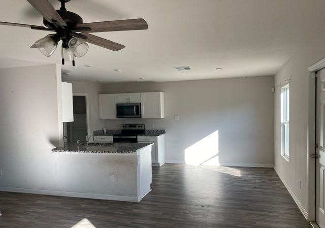 15532 Taylorcrest Drive Conroe, TX 77306 - Photo 25 of 36 a kitchen with stainless steel appliances granite countertop a refrigerator a stove a microwave oven with wooden floor and cabinets