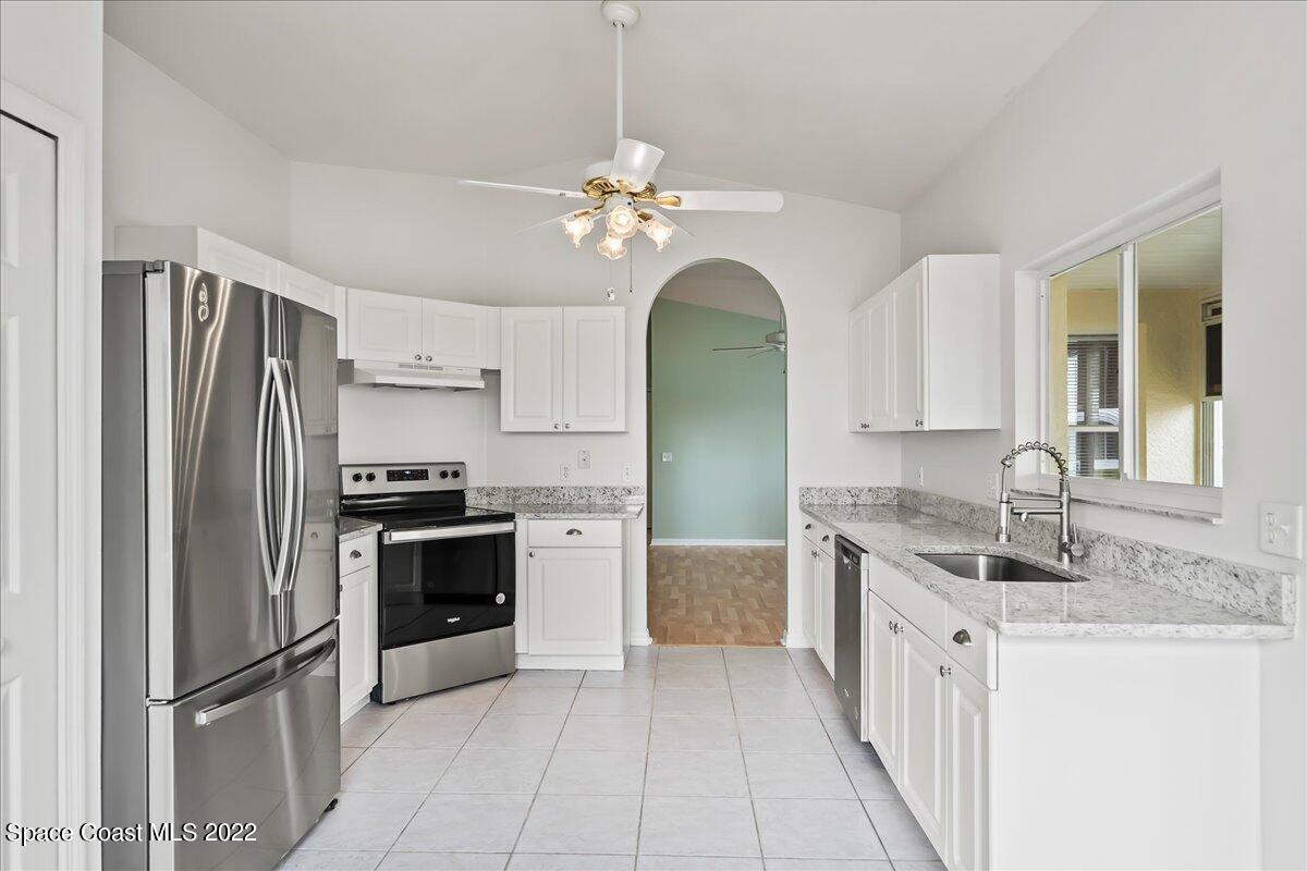 1965 Sundew Court Northeast Palm Bay, FL 32905 - Photo 11 of 29 a kitchen with stainless steel appliances granite countertop a refrigerator sink and stove