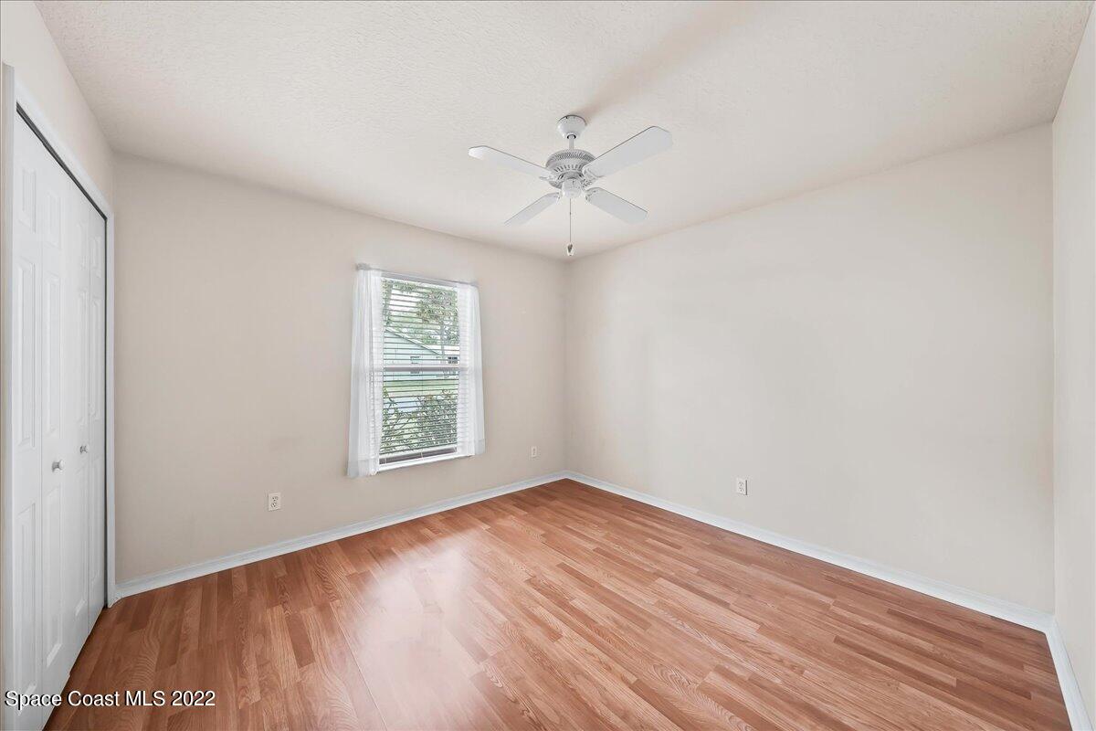 1965 Sundew Court Northeast Palm Bay, FL 32905 - Photo 12 of 29 wooden floor in an empty room with a window