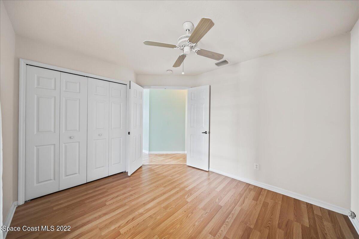 1965 Sundew Court Northeast Palm Bay, FL 32905 - Photo 17 of 29 a view of an empty room with wooden floor