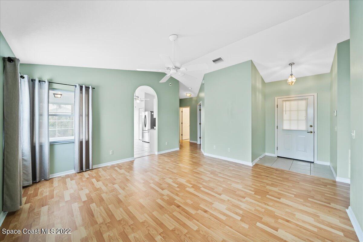 1965 Sundew Court Northeast Palm Bay, FL 32905 - Photo 19 of 29 a view of a big room with wooden floor and windows