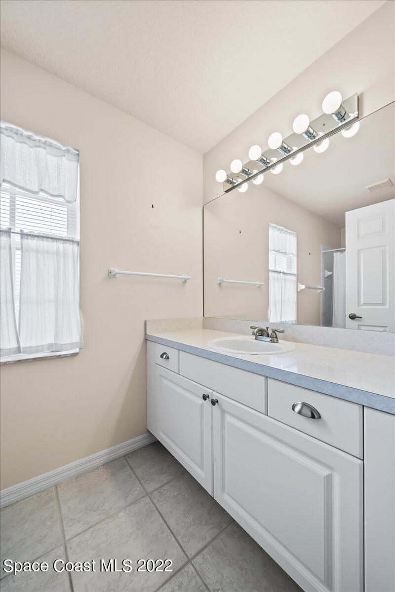 1965 Sundew Court Northeast Palm Bay, FL 32905 - Photo 23 of 29 a large white kitchen with a sink and chandelier