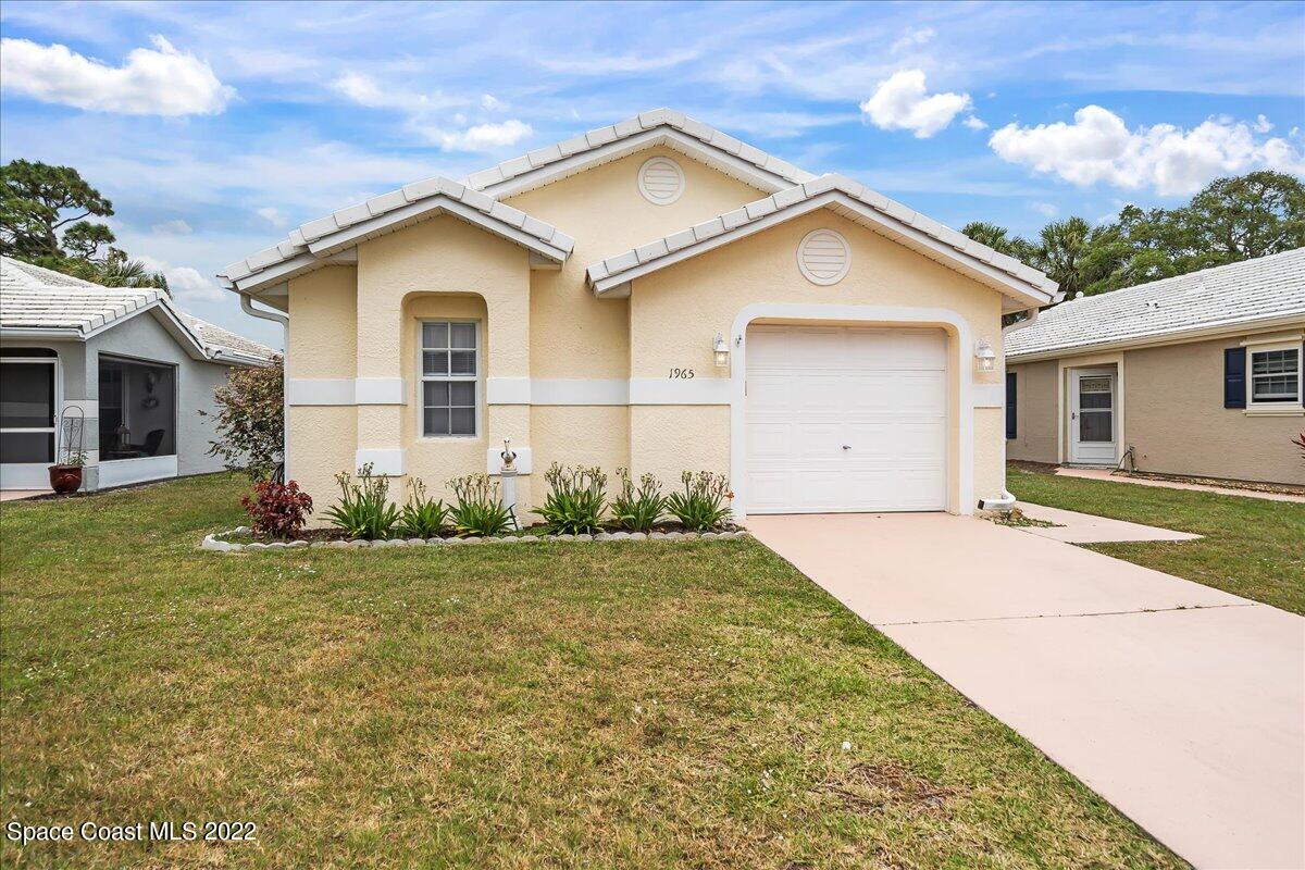 1965 Sundew Court Northeast Palm Bay, FL 32905 - Photo 29 of 29 a view of a house with backyard and garden