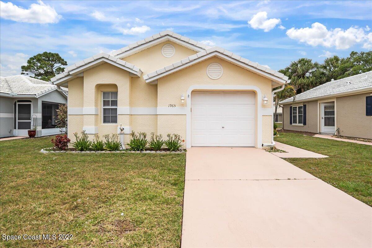 1965 Sundew Court Northeast Palm Bay, FL 32905 - Photo 4 of 29 a view of a house with backyard and garden