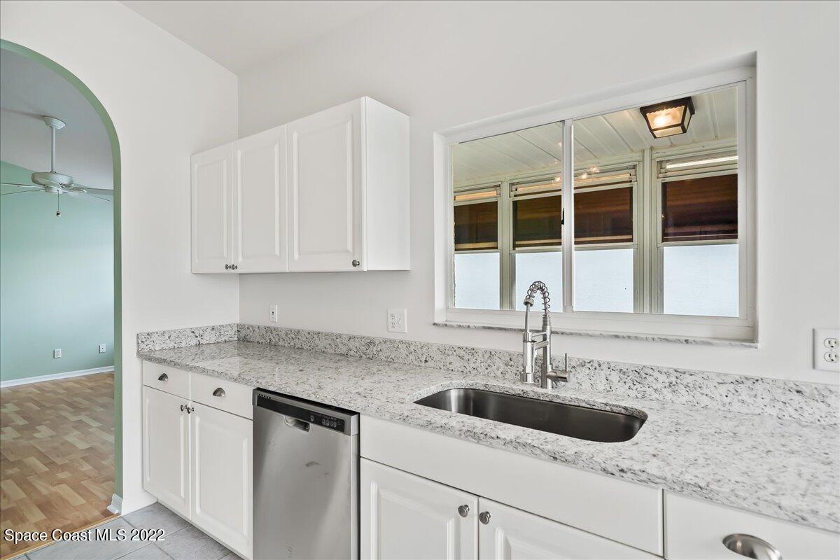 1965 Sundew Court Northeast Palm Bay, FL 32905 - Photo 9 of 29 a kitchen with stainless steel appliances granite countertop a sink and cabinets