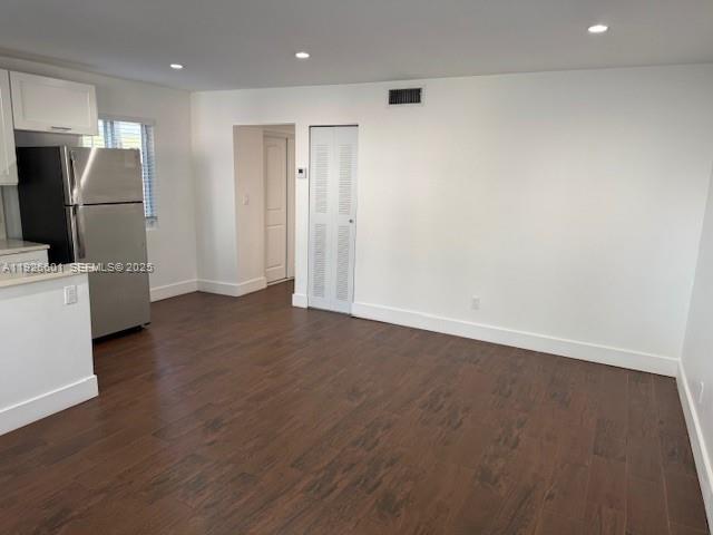 2006 Calais Drive, Unit 1 Miami Beach, FL 33141 - Photo 5 of 12 an empty room with wooden floor and windows