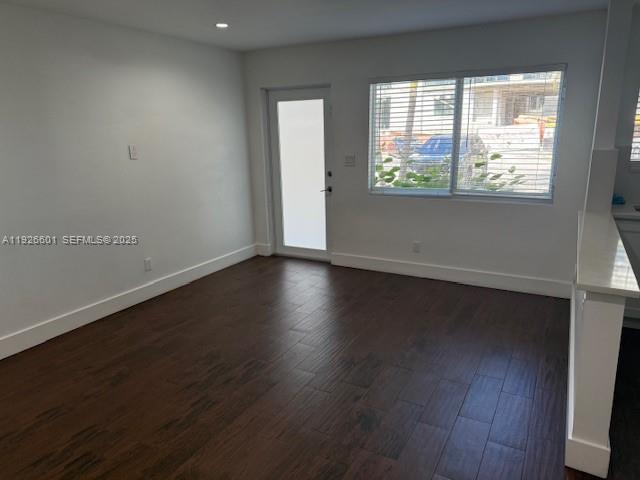 2006 Calais Drive, Unit 1 Miami Beach, FL 33141 - Photo 7 of 12 an empty room with wooden floor and windows
