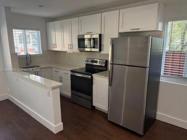 a kitchen with a refrigerator sink and stove