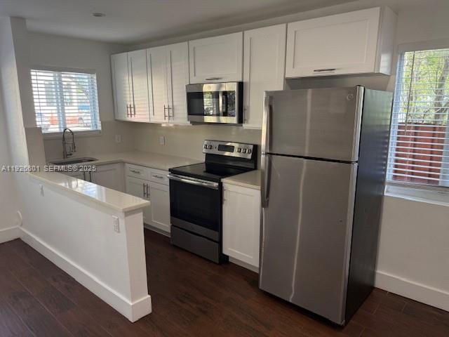 2006 Calais Drive, Unit 1 Miami Beach, FL 33141 - Photo 8 of 12 a kitchen with a refrigerator sink and stove