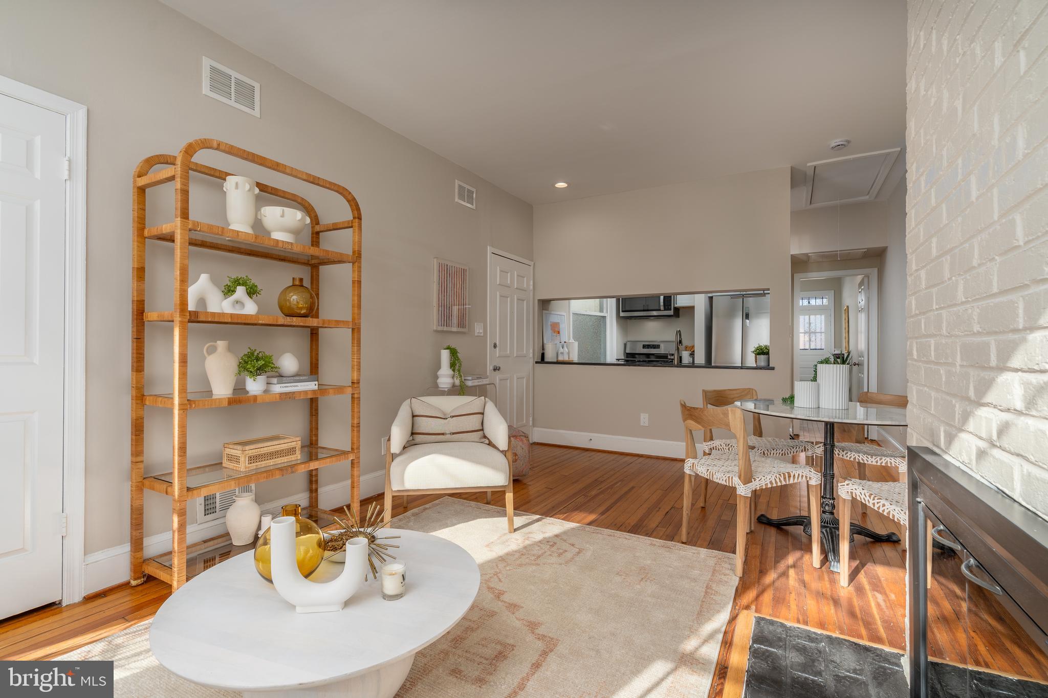 1218 D Street Southeast, Unit 4 Washington, DC 20003 - Photo 12 of 30 a living room with furniture a wooden floor and kitchen view