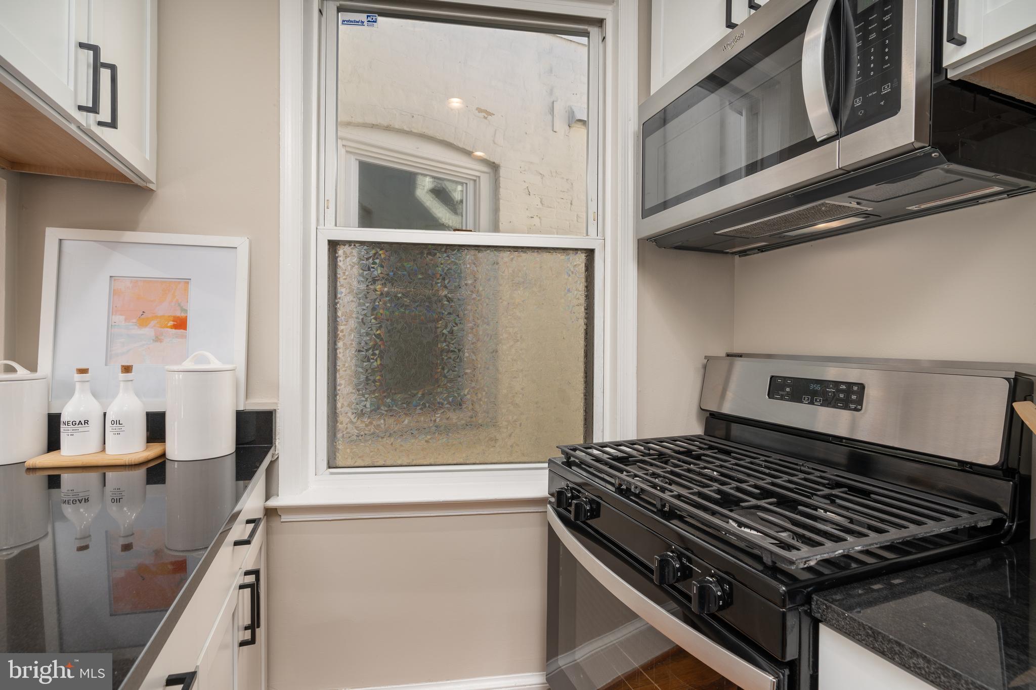 1218 D Street Southeast, Unit 4 Washington, DC 20003 - Photo 15 of 30 a stove top oven sitting inside of a kitchen