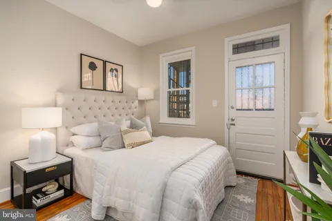 a bedroom with a bed and a night stand