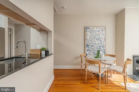 a view of a kitchen with dining table and chairs