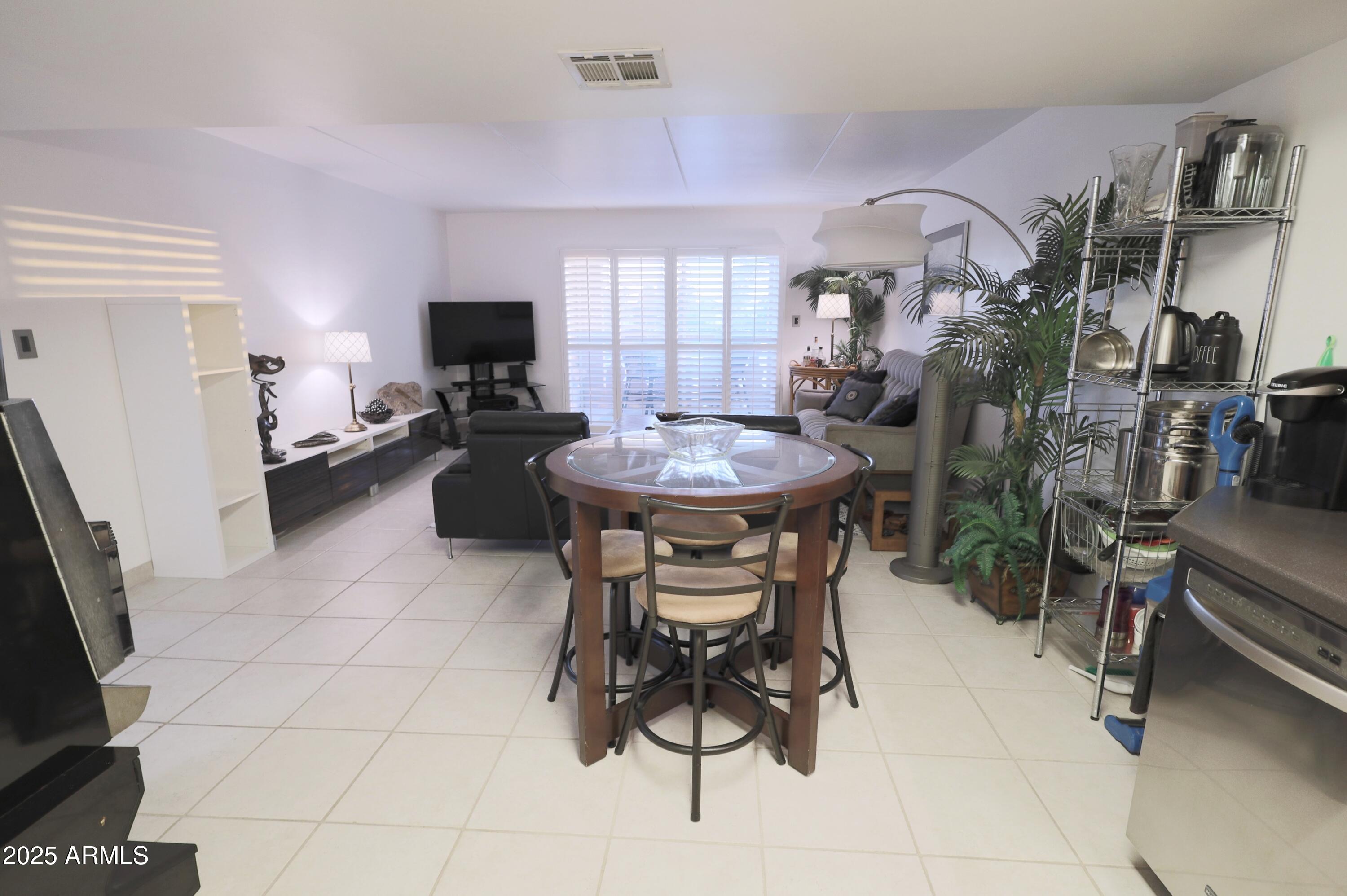 7820 East Camelback Road, Unit 309 Scottsdale, AZ 85251 - Photo 11 of 55 a dining room with furniture and a flat screen tv